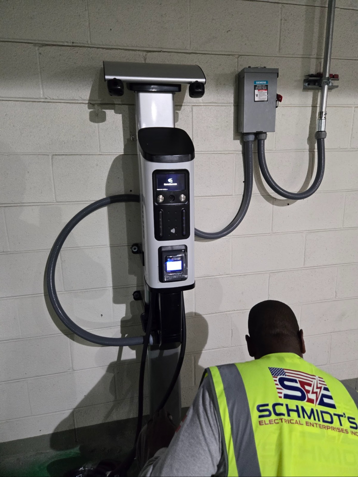Schmidt's technician installing an EV charger in a garage in Washington, DC — Schmidt's Electrical